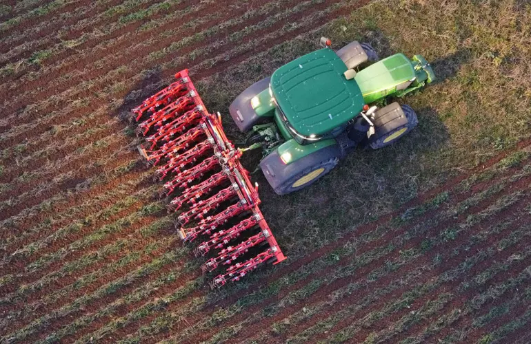 view from above of a strip till machinery working in a field at night