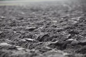 close-up view of a plowed field with rough and uneven soil